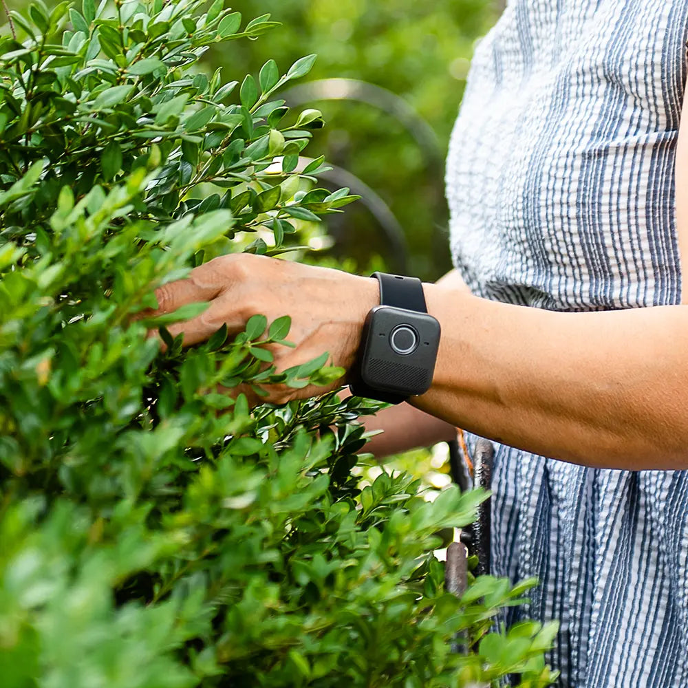 A person working on landscaping wearing a Belle W watch.
