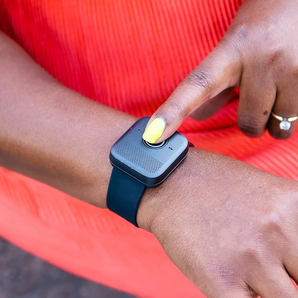 Person wearing a Belle W watch pushing the call button. 