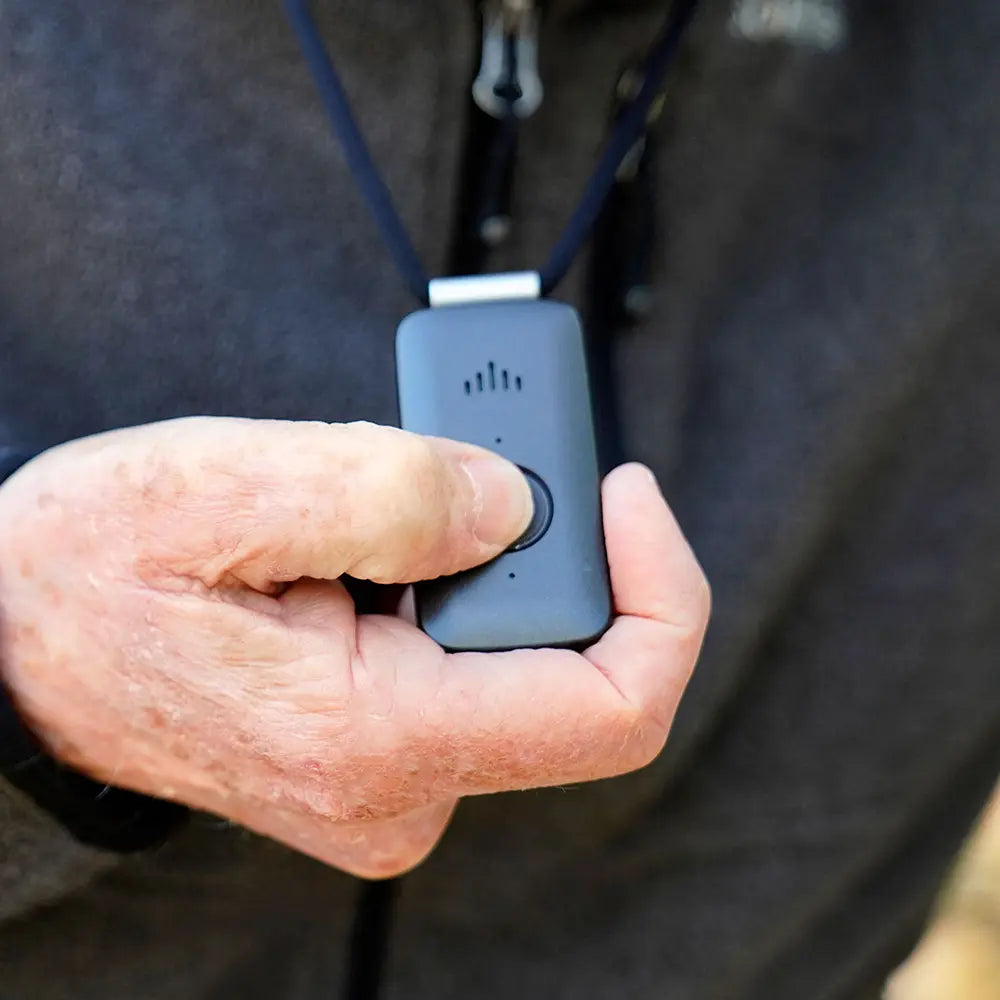 Person pushing the call button on their Belle X pendant.