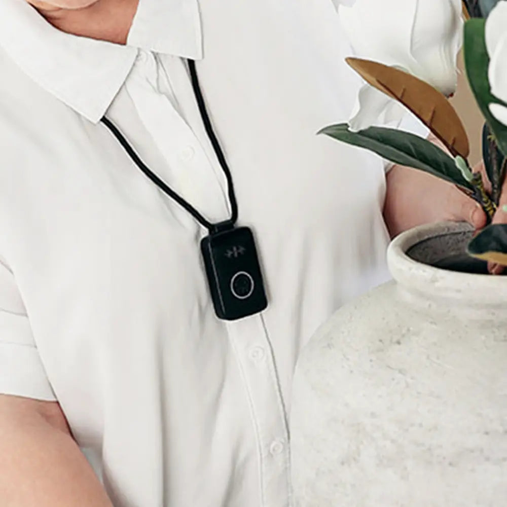 Person wearing a Belle device on a lanyard.